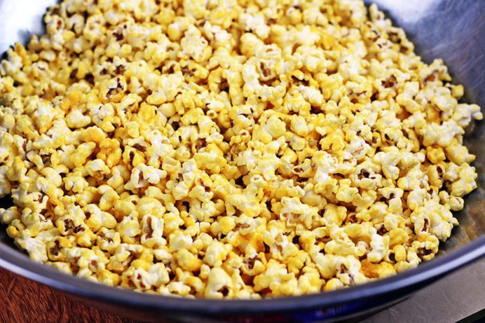 Easy Homemade Cheddar Cheese Popcorn recipe ready in just 5 minutes with cheddar cheese powder, popcorn and butter. Perfect for movie night!