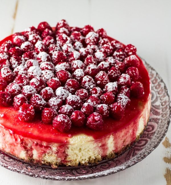 Only a few things in life are as good as this silky Classic Cheesecake. Smooth, creamy and topped with a tangy raspberry sauce! A showstopper that is guaranteed to become your new favorite cheesecake recipe.