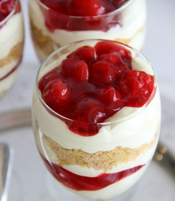 Mini Cherry Cheesecake Trifles – A wonderful cheesecake pudding layered with cherry pie filling and crushed graham crackers make a wonderful dessert!