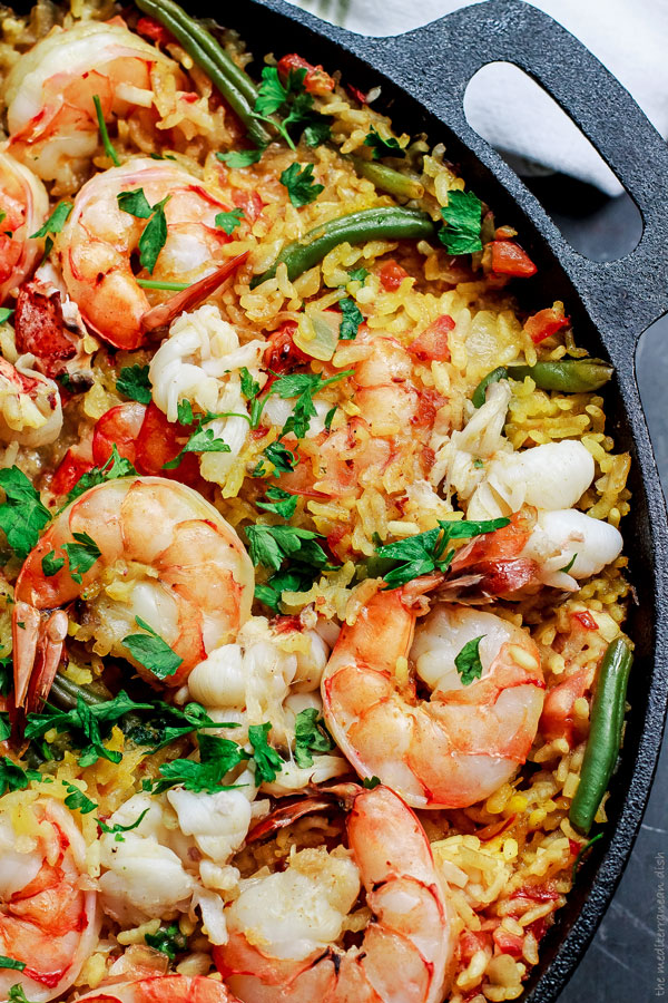 This saffron-infused easy seafood paella with shrimp and lobster is a simpler take on the traditional beloved Spanish dish with fewer ingredients and no special pan.