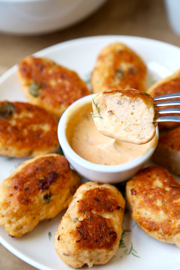Salmon croquettes are light and tasty and take less than 15 minutes to prep. They are served with a slightly spicy sriracha dipping sauce that will keep you coming back for more.