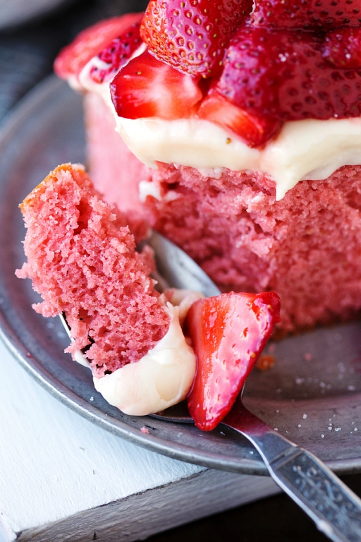 A delicious, homemade-from-scratch best ever strawberry cake with a thick cream cheese frosting and garnished with sugared strawberries.