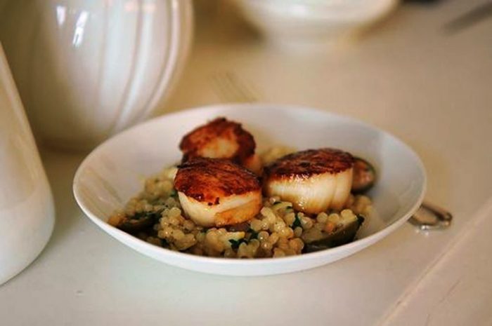 Couscous with roasted lemon and capers topped with seared scallops