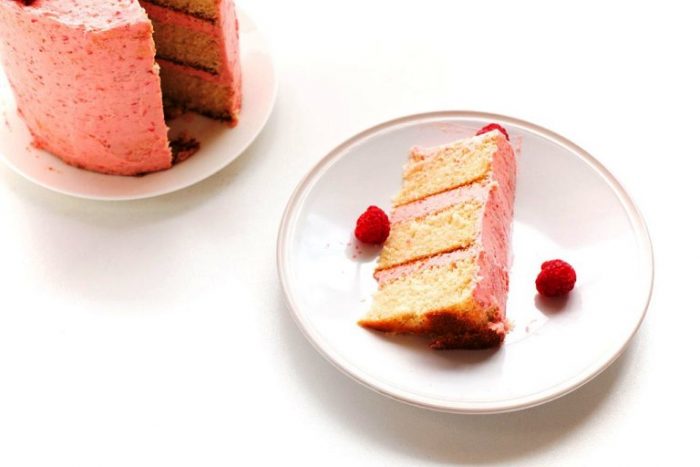 A delicious vanilla cake recipe that is easy to make and is perfectly moist and soft. Filled and topped with a delicious and creamy raspberry buttercream.