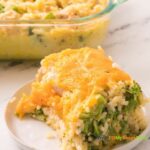 Creamy Chicken Broccoli Rice Casserole recipe idea that is an easy oven bake for family meal, topped with cheese and herbs.