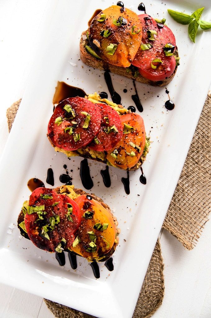 Avocado and heirloom tomato toast with balsamic drizzled