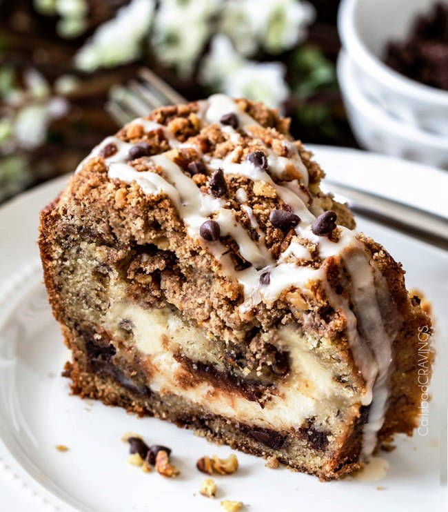 This Banana Coffee Cake is made with banana cake batter, riddled with chocolate chips and walnuts (optional) with an INCREDIBLY creamy cream cheese filling all showered with Cinnamon Walnut Streusel and Vanilla Drizzle.