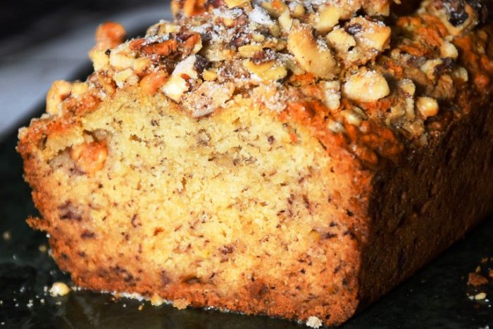 Maple Walnut Banana Bread is a sugar-free quick bread made with pure maple syrup and topped with walnuts prior to baking.