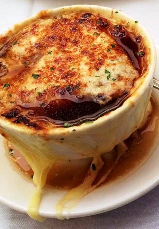 French Onion Soup from Famous & Barr in St. Louis, Missouri. Nothing is as reminiscent of Famous as this iconic French onion soup.  The soup was thick and rich, bubbling with melted cheese atop two slices of French baguette.
