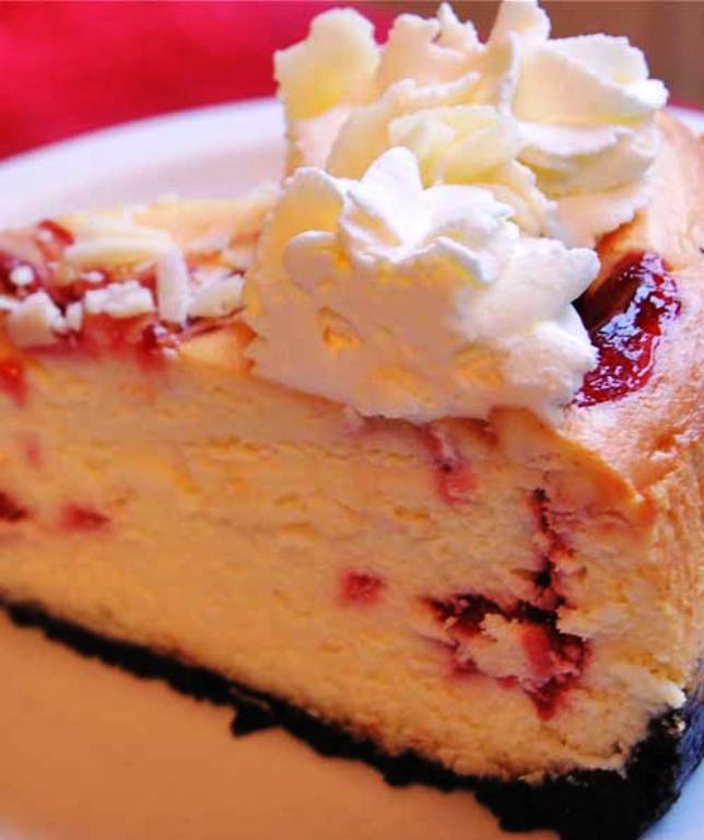 This Copycat Cheesecake Factory White Chocolate Raspberry Truffle Cheesecake recipe is both of those things!