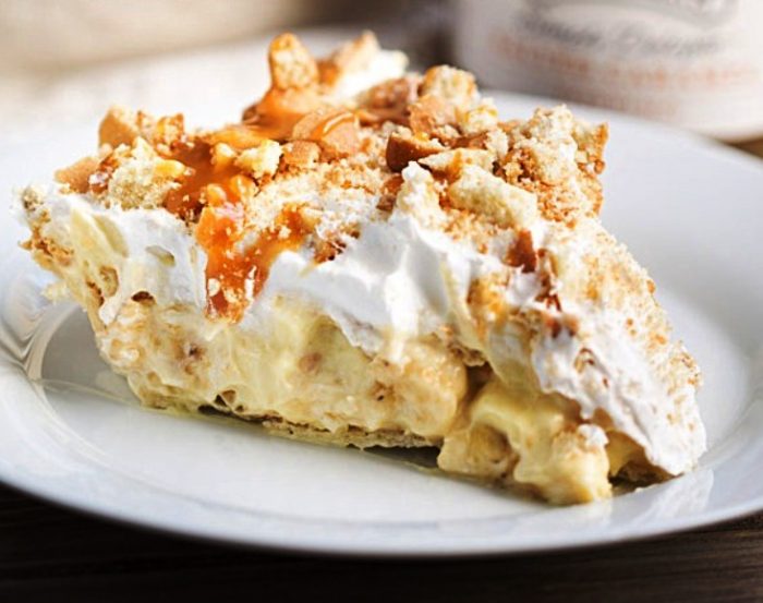 Crowd pleasing Banana Pudding Pie is ready to serve in under a half hour! The only thing you have to bake is the crust. Creamy vanilla pudding is filled with fresh bananas and vanilla wafers, topped with Cool Whip, vanilla wafers and a drizzle of caramel sauce. 