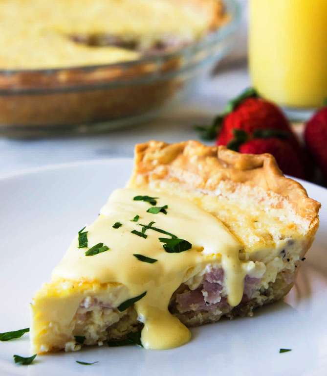 This super easy to make quiche comes out with perfectly flakey crust, creamy egg and bites of canadian bacon.  Not to mention it’s smothered in an easy to make blender hollandaise sauce.  Perfect for brunch!