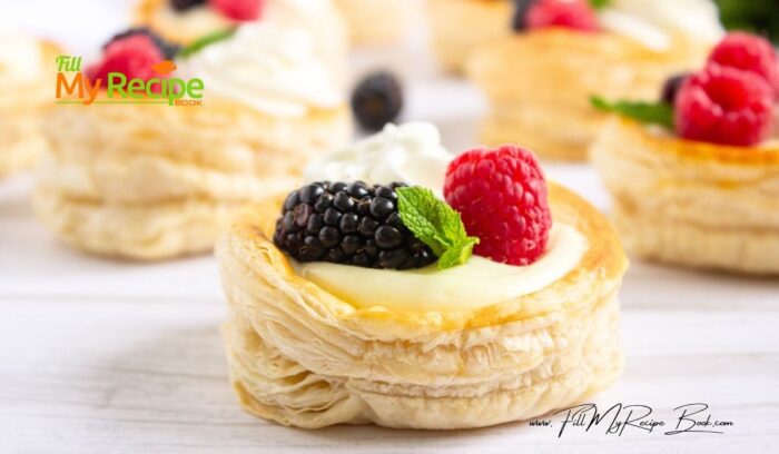 An easy Vanilla Cream Puff Pastry recipe idea for a dessert. Oven baked, topped with whipped cream and garnished with raspberries, mint.