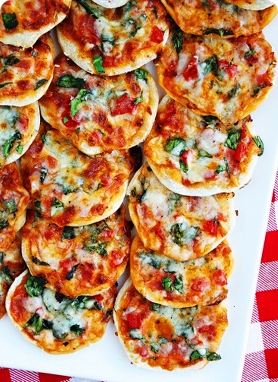 Mini pizzas on homemade thin crust dough + tons of topping ideas! These little bites are perfect for parties and fun for weeknights!