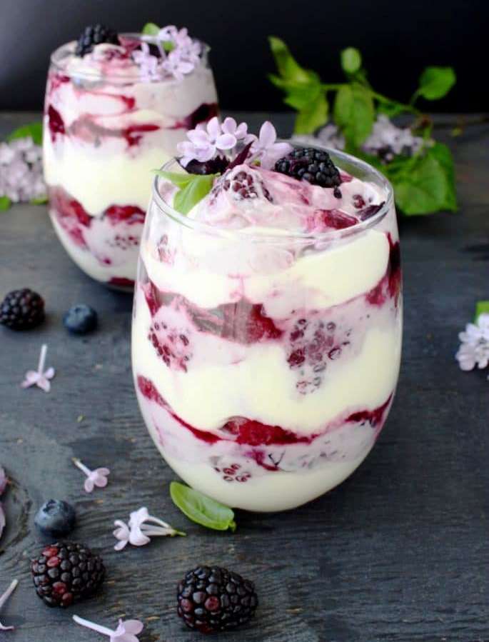 Easy, no alcohol, no bake berry tiramisu trifle made with Mascarpone cream cheese, lady fingers and a blackberry blueberry puree.