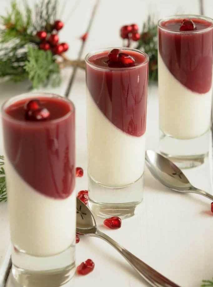 Pomegranate Panna Cotta is an easy, yet striking dessert. Creamy, orange flavored chilled cream is layered with a pomegranate jello and served in individual glasses. A festive and fun holiday dessert that can be made a day ahead and can sit refrigerated until ready to serve.