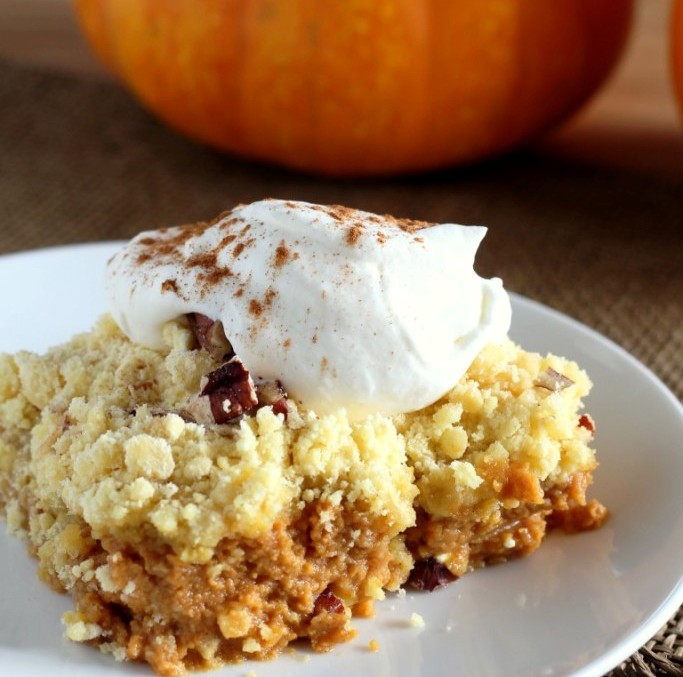 This Pumpkin Crunch Cake tastes like a pumpkin pie with a crunchy pecan streusel layer on top – and it’s easily made with a box of yellow cake mix.