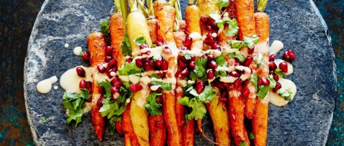 Sweet and nutty and topped with juicy pomegranate seeds, these are a far cry from your normal roast veggies. This vegan dish will serve four as a side dish.