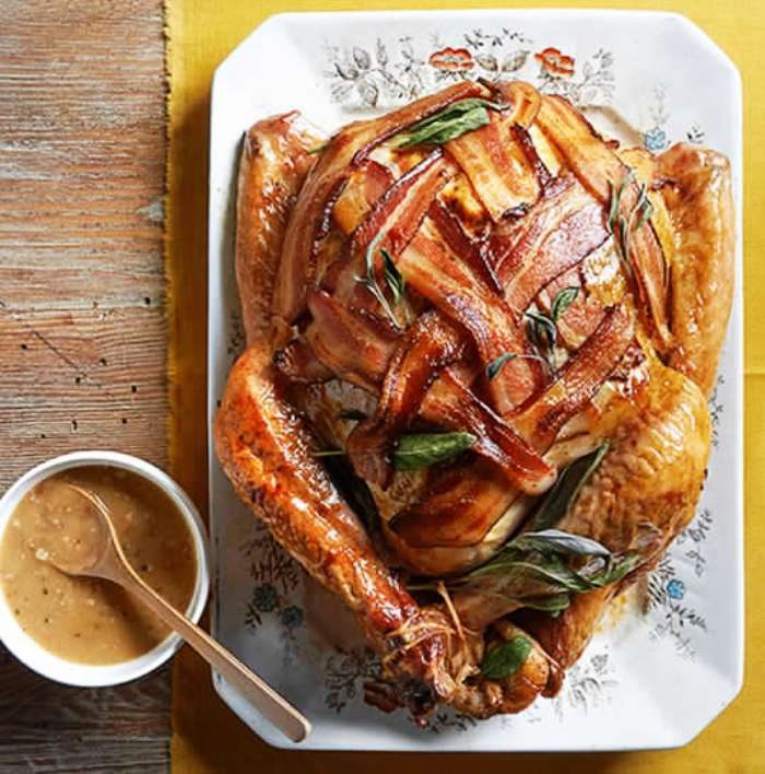 This Bacon Wrapped Turkey recipe is a delicious, crowd-pleasing centerpiece for your Thanksgiving meal. Drizzle each serving with Bacon and Onion Gravy that's accented with a pinch of fresh sage.