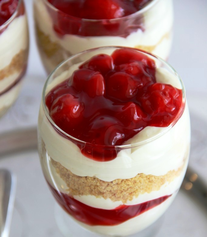 Mini Cherry Cheesecake Trifles – A wonderful cheesecake pudding layered with cherry pie filling and crushed graham crackers make a wonderful dessert!