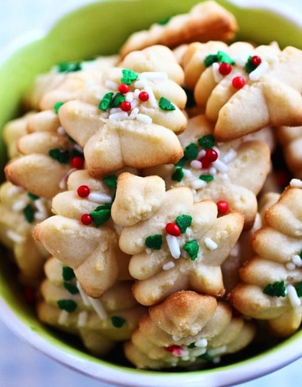 the BEST, buttery, melt-in-your-mouth and crumbliest Christmas Spritz cookies ever! Super easy recipe that anyone can bake this holiday season.
