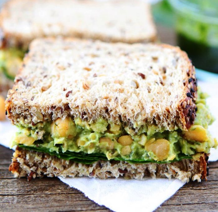 Smashed chickpea, avocado, and pesto salad sandwich