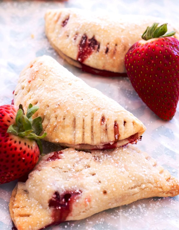 These easy strawberry hand pies with cream cheese crust and filled with homemade strawberry pie filling! This strawberry hand pie recipe is perfect for spring or summer dessert.