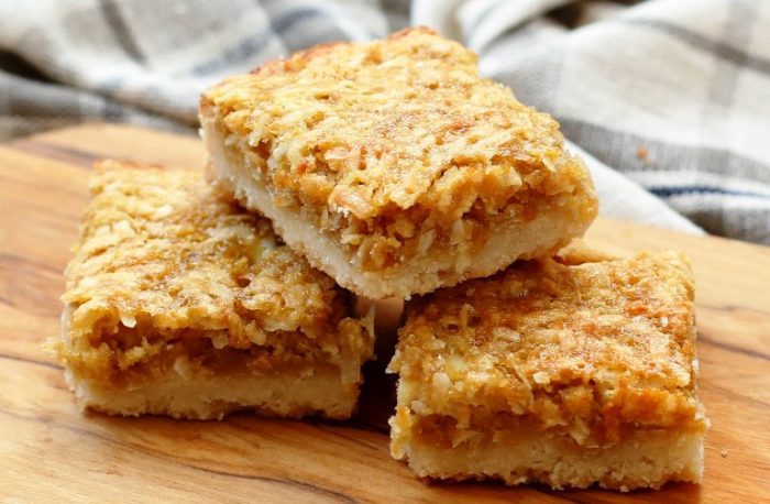 Chewy coconut filling layered onto a buttery shortbread crust; this recipe is so simple to make I have been making it since I was a child. 