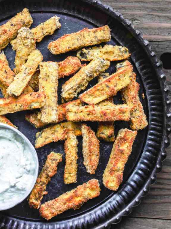 These simple baked eggplant fries are the perfect snack or appetizer for a crowd. Crispy on the outside, velvety tender on the inside!  I love to serve these with a side of Greek Tzatziki sauce. 