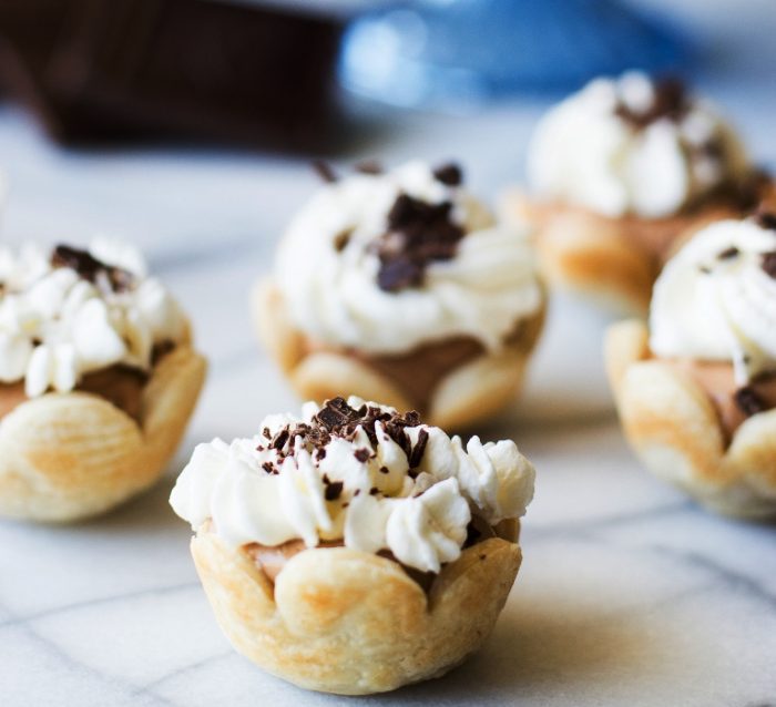 Mini French Silk Pies. Easy to make than you probably think and decadently DELICIOUS! Silky, creamy, chocolate bliss topped with homemade whipped cream. All in bite size mini pies!