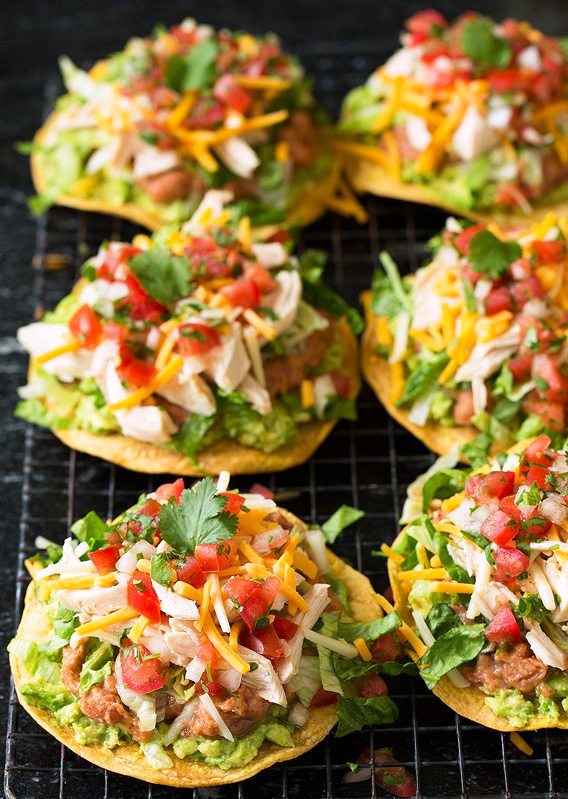 These Tostadas with Chicken Beans and Guacamole are perfect for an easy weeknight dinner! These are piled high with layer after layer of deliciousness and you’ll be savoring every bite. It’s one of those tasty recipes the whole family can agree on!