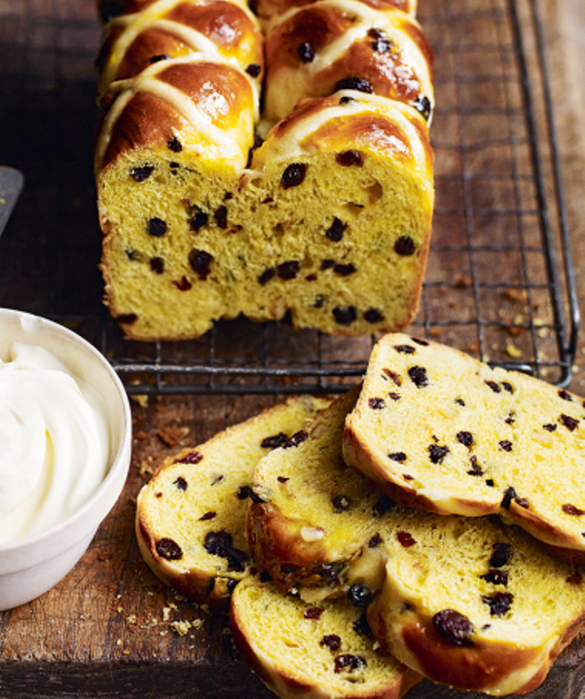 These hot cross bun loaf flavoured with aromatic saffron and served with clotted cream for a delicious Easter weekend treat.