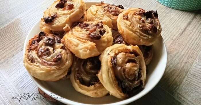 Easy Puff Pastry Raisin Roll Ups recipe idea with cream cheese. A delicious simple treat to bake in the oven with cinnamon and flaky pastry.