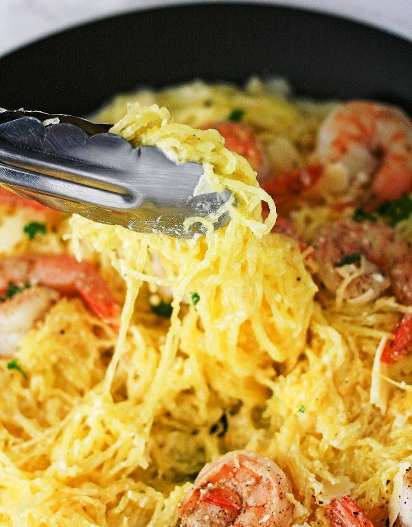 Garlic Shrimp Spaghetti Squash a delicious low carb healthy dinner that is packed with flavor. This is sure to be a crowd pleaser without the extra calories.