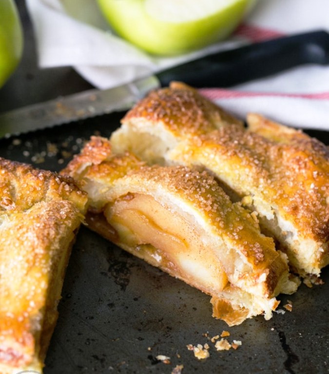 This apple slab pie is loaded with caramelized apples and wrapped in a flaky puff pastry crust. The filling tastes like an apple pie but it’s even easier. It’s so easy and quick to whip up and you don’t even have to struggle with making your own dough; a store-bought puff pastry will work just fine. You can use your favorite apples for this but there’s nothing quite like a caramelized, slightly tart granny smith.