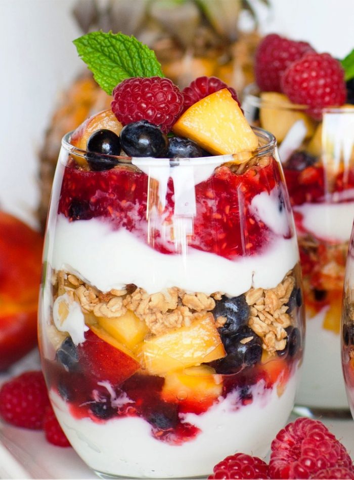 These colorful fruit parfaits are made with plain Greek yogurt, home-made raspberry sauce, tons of fresh fruit and crunchy granola! Enjoy these yogurt and granola parfait cups for breakfast, lunch, snack or dessert!
