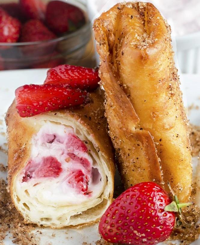 Creamy cheesecake filing with fresh strawberries, rolled in tortillas and coated with cinnamon sugar.