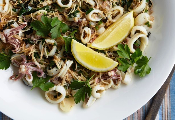 The key to preparing calamari is to either cook it really fast or really slow; anything in between will leave you with a chewy texture. Serve this in a big bowl as part of an antipasti spread or as individual servings.