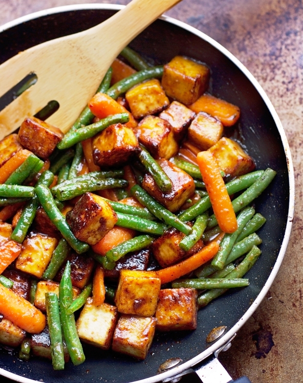 This easy recipe starts with a homemade sesame ginger sauce that coats the crispy tofu and perfectly al-dente carrots and green beans.