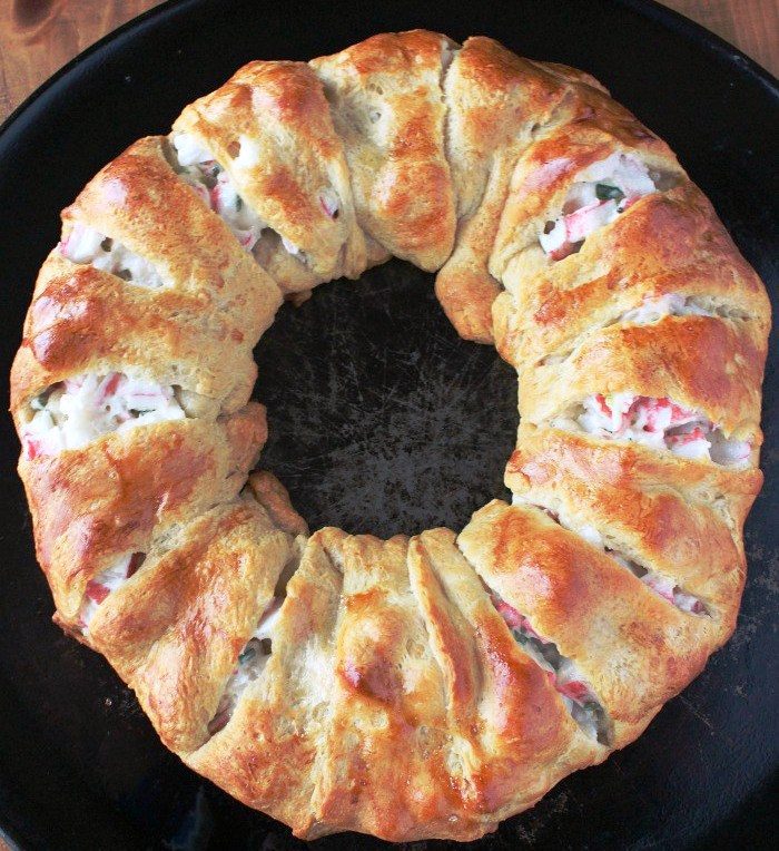 With crispy, flaky crescent rolls filled a delicious crab and cream cheese mixture, this Crab & Cream Cheese Crescent Ring Recipe is simple and scrumptious!