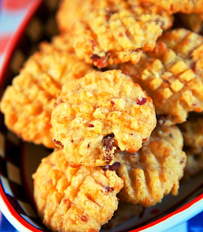 Cheddar Bacon Crackers – quick homemade bacon and cheddar cheese crackers. These things fly off the plate at parties! Super easy to make and they taste fantastic! Flour, baking powder, cayenne, butter, cheese, bacon, and milk. 
