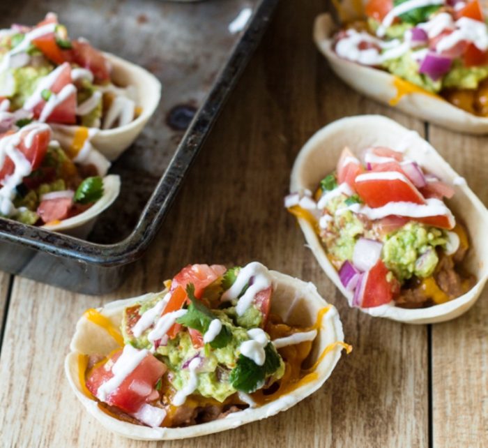 Get all of that layered bean dip flavor with much less work in these two-bite snacks. Like miniature bean burritos, these bean dip bites are topped with melty cheese, seasoned guacamole, fresh pico de gallo, and tangy sour cream. 