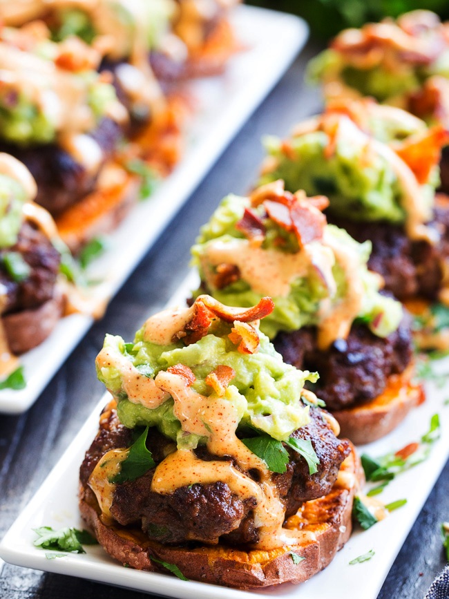 Taco-seasoned mini burger patties over roasted sweet potato “buns” topped with an easy guacamole, chipotle ranch and crumbled bacon. Perfect as an appetizer, party food or a fun meal! Paleo and Whole30 compliant, family approved!