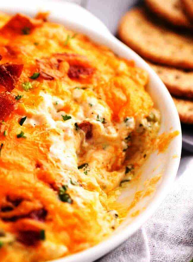 Hot Bacon Cheddar dip is hot, cheesy and loaded with flavor! The perfect party dip for crackers or chips!