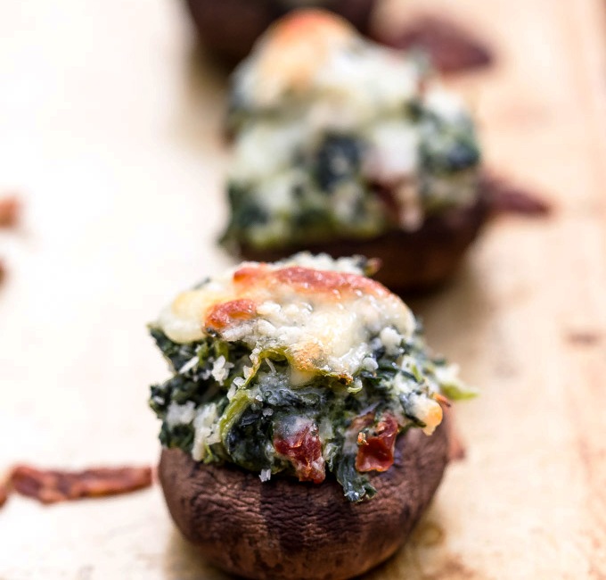 No need for crackers or chips with this dip, stuff a mushroom instead! These Spinach and Sun Dried Tomato Dip Stuffed Mushrooms are packed with flavor and perfect for parties.