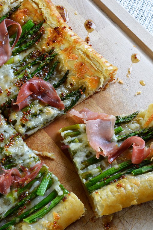 Golden puff pastry topped with fresh asparagus, cheese, prosciutto and a drizzle of honey mustard sauce!