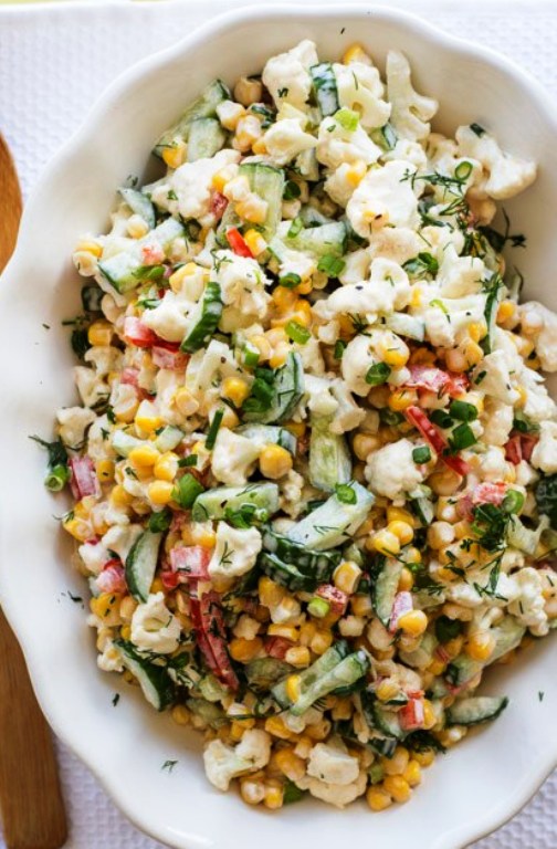 The BEST creamy cauliflower corn salad recipe. An easy corn salad that is loaded with cauliflower florets, cucumbers, bell peppers, and dill all tossed in a creamy homemade dressing.