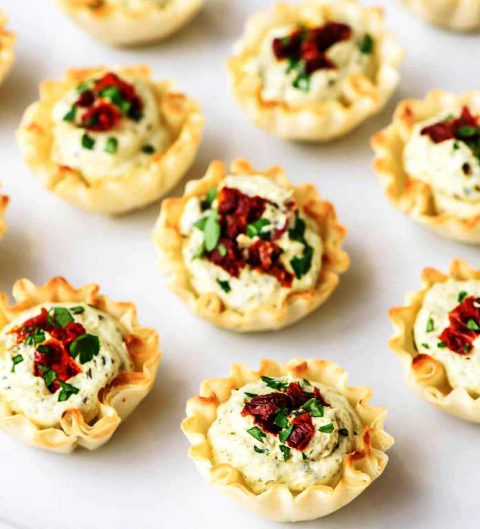 I had the best of intentions to scour thrift stores in an effort to score the cheesiest of all holiday sweaters, preferably one with pom-poms and a faux-fur collar. While I’ve yet to begin my hunt, I have been busy dressing my food in red and green, including today’s Christmas Appetizer Bites.