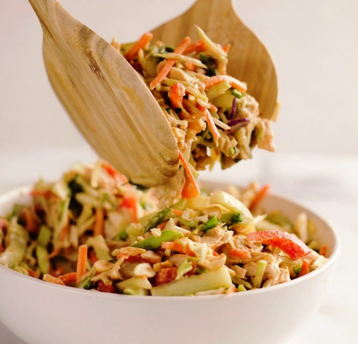 Thai Peanut Chicken Crunch Slaw Salad is an easy & healthy 20 minute salad with Asian inspired flavors. It is loaded coleslaw, broccoli slaw, vegetables and rotisserie chicken and dressed with a homemade Thai Peanut Sauce and peanuts for amazing flavor and crunch!