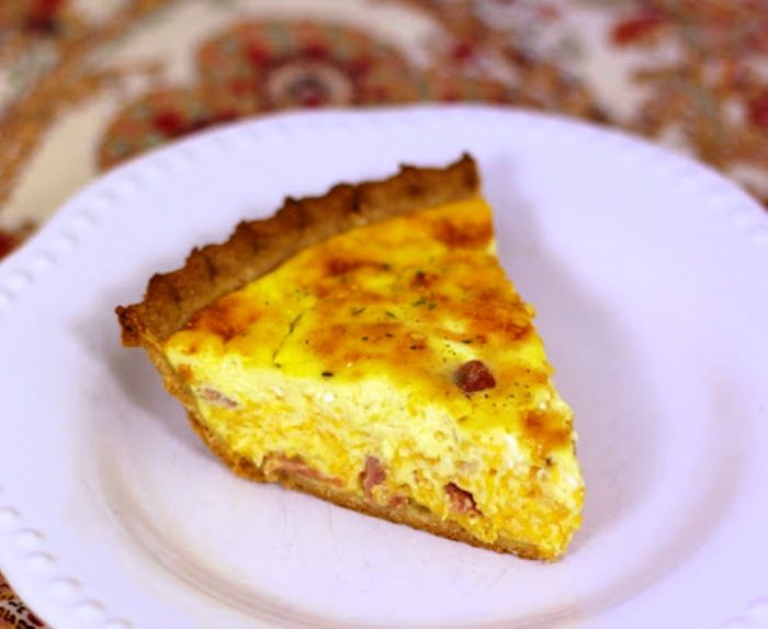 Honey Ham and Cheese Quiche Recipe– great for breakfast, lunch, and dinner. Super simple to make and tastes great! Ham, cheese, honey mustard, eggs, heavy cream, sour cream, and pie crust. Our favorite flavors!
